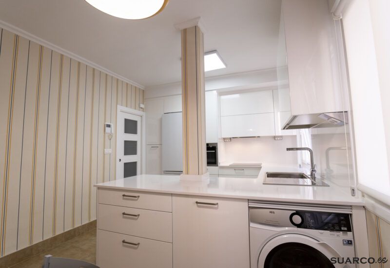 Cocina blanca abierta al salón con península Suarco