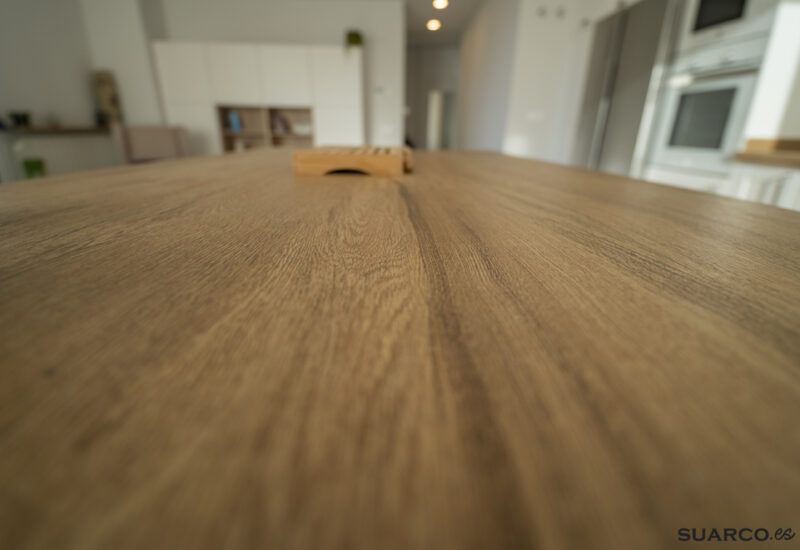 Cocina blanca con isla y encimera de madera. Cocinas Suarco